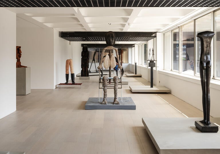 A shot of the gallery, showing sculptures by Giacometti and Huma Bhabha.