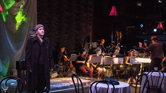 Man on stage with orchestra