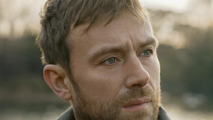 A headshot of Damon Albarn looking to the distance