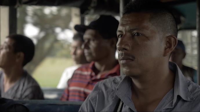 a group of men sit on a bus