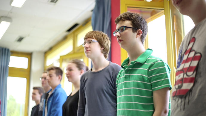 a line of school children stand next to each other