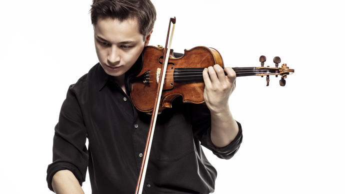 Johan Dalene plays his violin, looking down at the ground