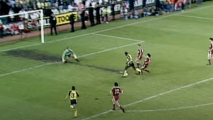 Michael Thomas of Arsenal prepares to shoot against Bruce Grobbelaar in the final moments of Liverpool v Arsenal at Anfield in 1989