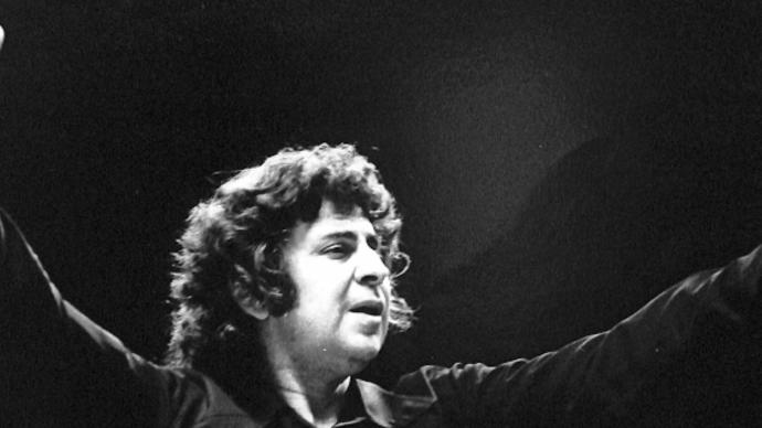 black and white performance photo of mikis theodorakis