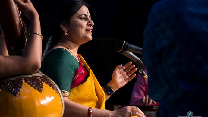 Woman playing classical Indian instrument 