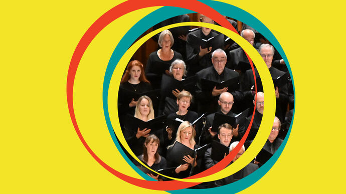 BBC Symphony Chorus are in the centre of the image, surrounded by yellow BBC Symphony Orchestra branding