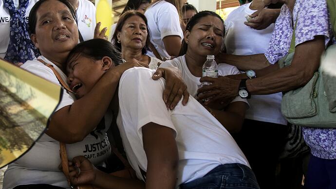 A group of people lock arms