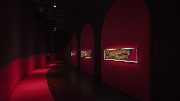 The Curve gallery in red lighting showing drawings by Soufiane Ababri on the walls