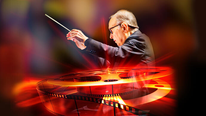 Ennio Morricone conducting, with an image of a reel of film in glowing red colours overlaid