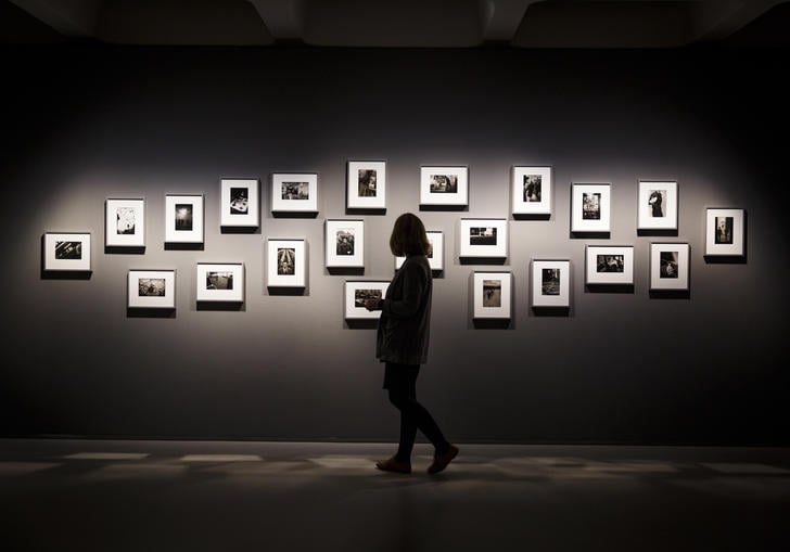 Silhouette of woman looking at photographs