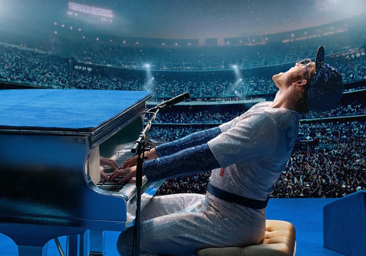 Taron Egerton as Elton John singing at a piano