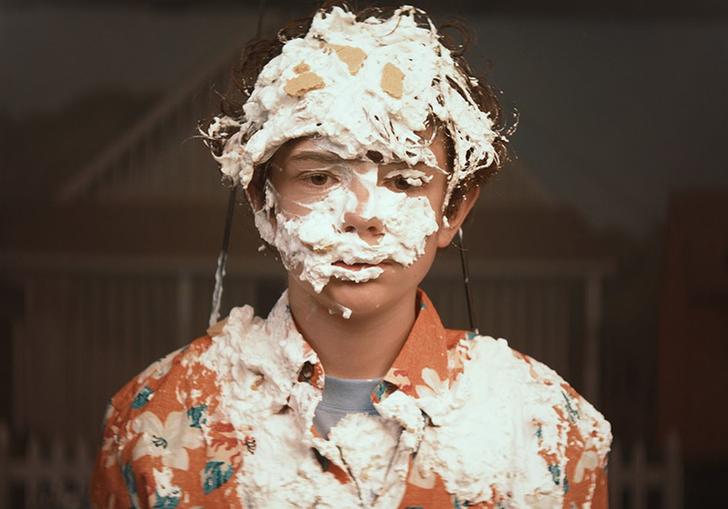 young Otis covered in cream from a cream pie
