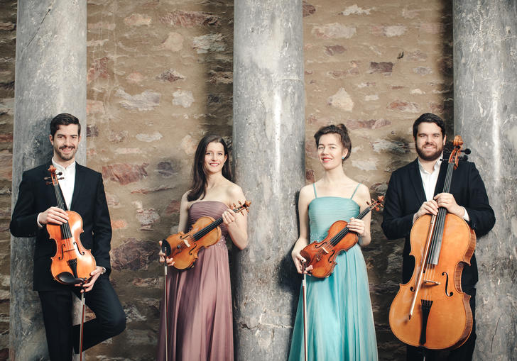 The Aris Quartet posing with their instruments 
