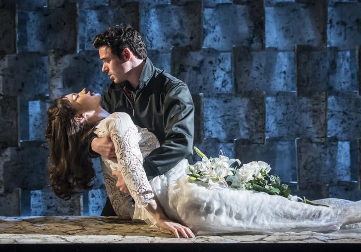 Richard Madden as Romeo holds Lily James as Juliet