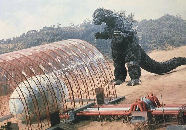 Godzilla dominates a landscape.