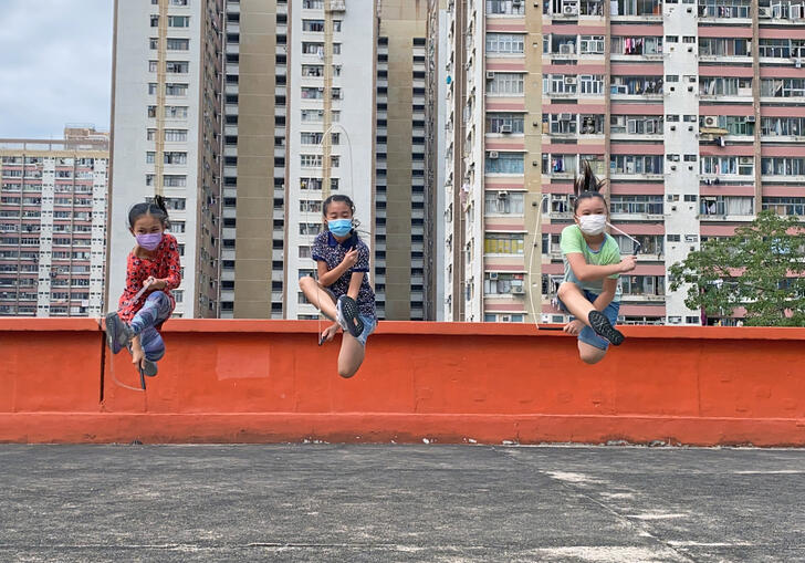 three girls in mid-air with skipping ropes