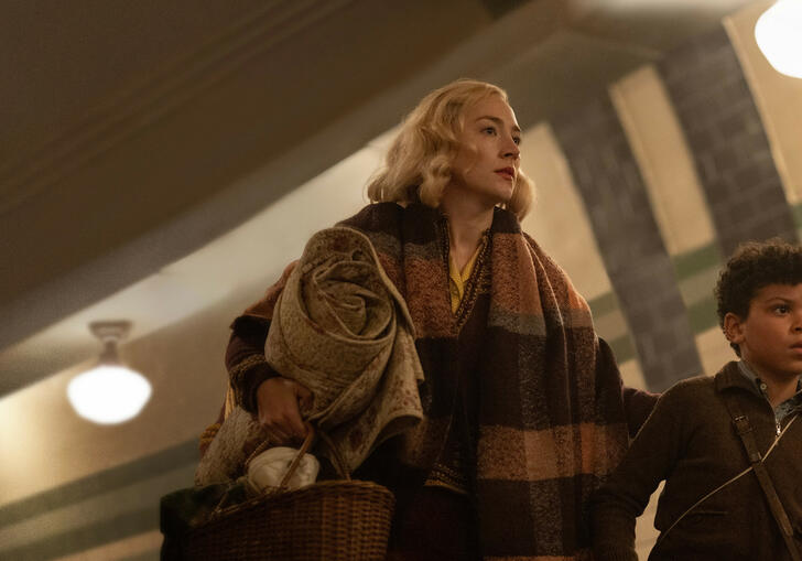 A mother and son run through the London underground.