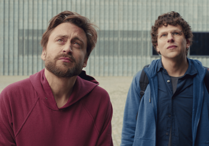 Two middle-aged men stare skywards.