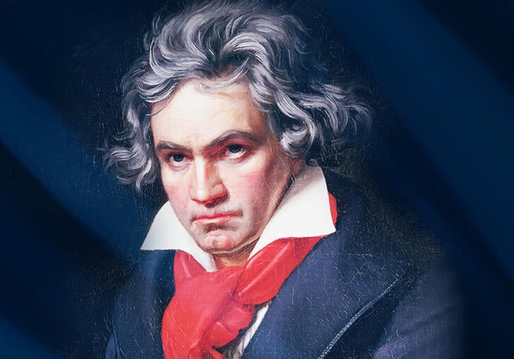 A portrait of Beethoven in a black suit jacket and a red shirt