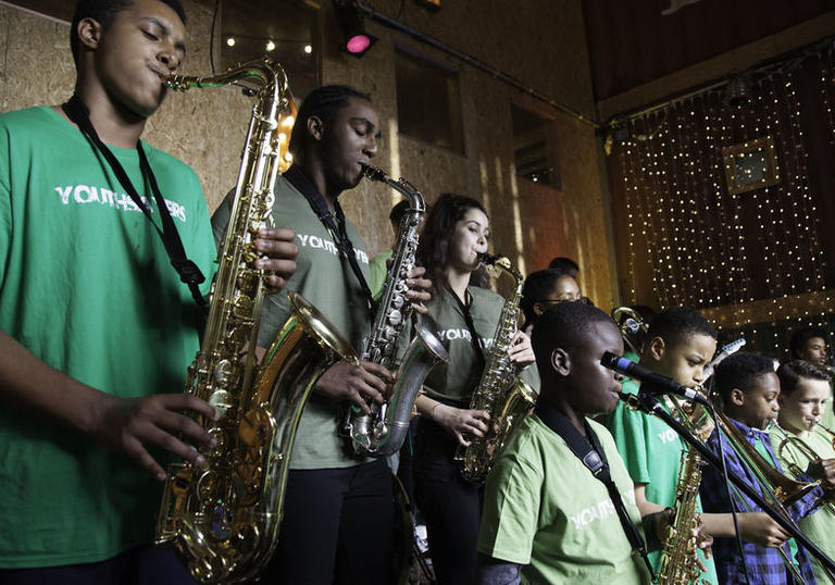 Photo of group of people playing saxophone