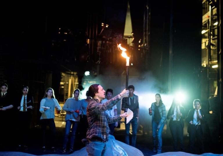 Photo of an actor leading a backstage tour in a theatre