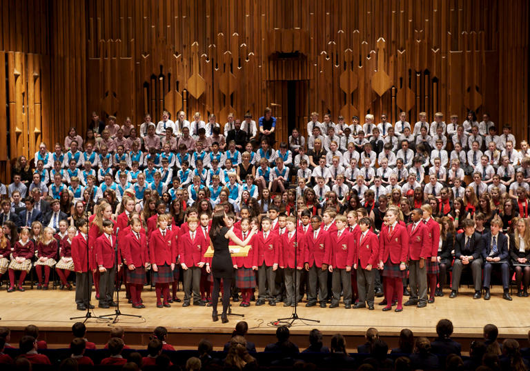Barnardo's choir singing on stage at the Barbican