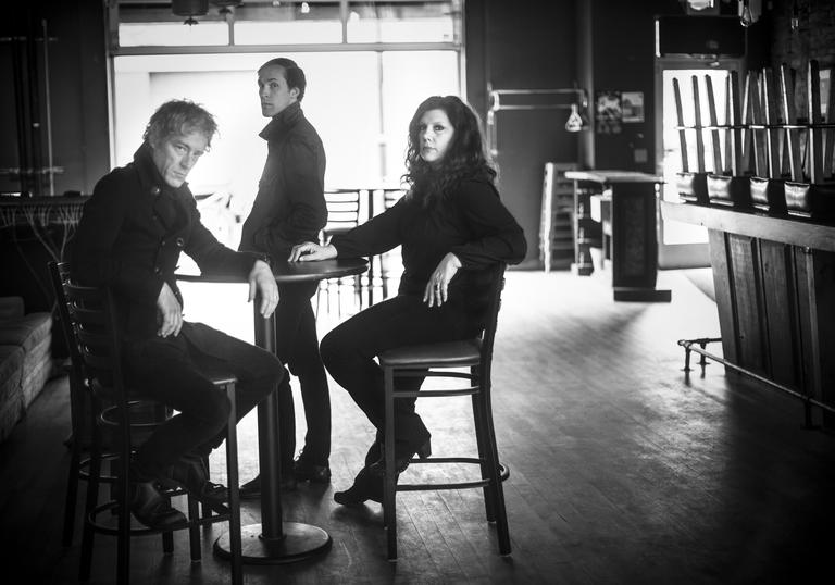 Low sit at a wooden table in an empty bar