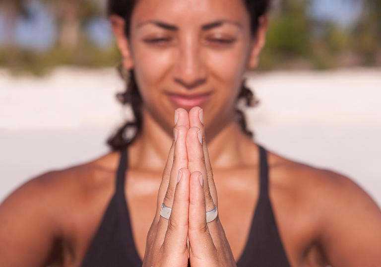 A person pushing their hands together in a yoga pose