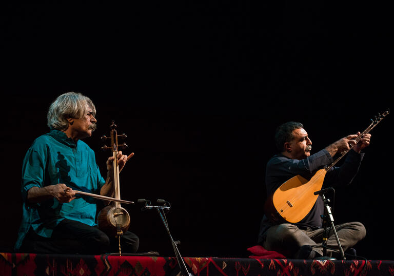 Kayhan Kalhor and Erdal Erzincan performing on stage with instruments