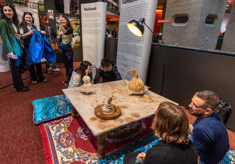 Image of people sat down at an exhibtion