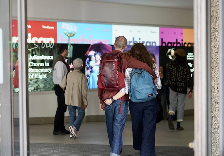 Image of couple walking into the Barbican entrance