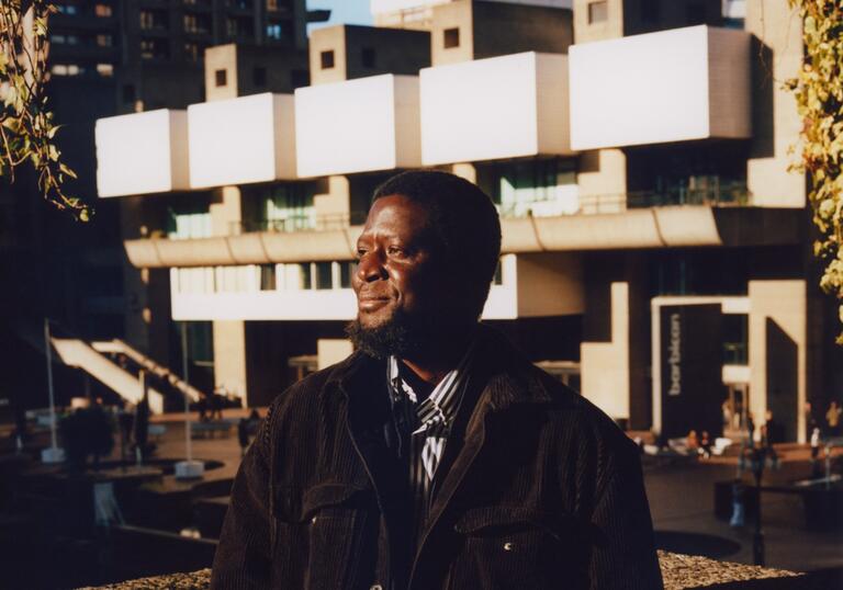 ibrahim mahama stands in front of barbican lakeside terrace