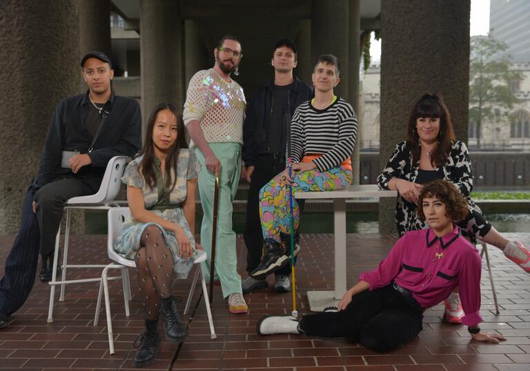 The 2022 cohort of Open Lab artists gather on the Barbican Lakeside Terrace and pose for a photo.