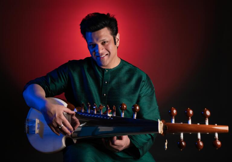 Amaan Ali Bangash holding a sarod