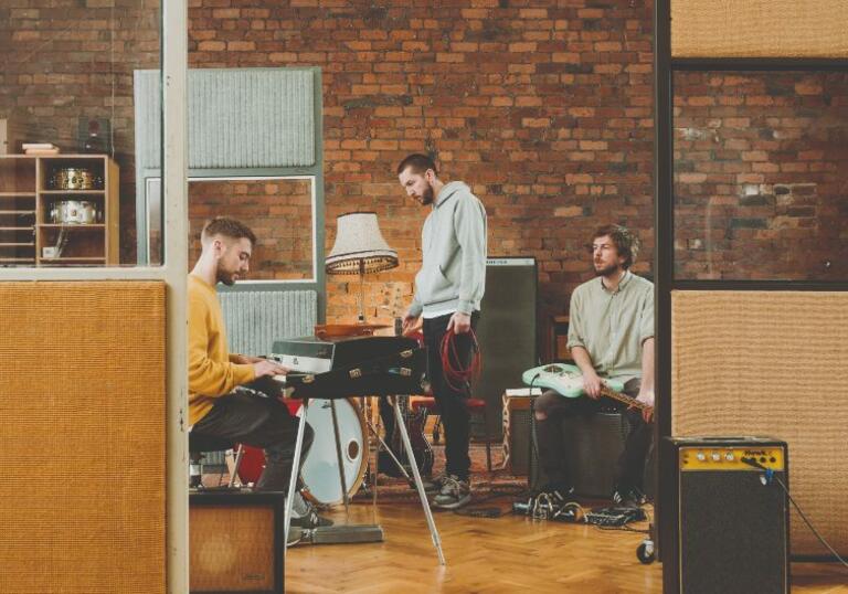 Gott Street Park Trio sit at instruments in their studio