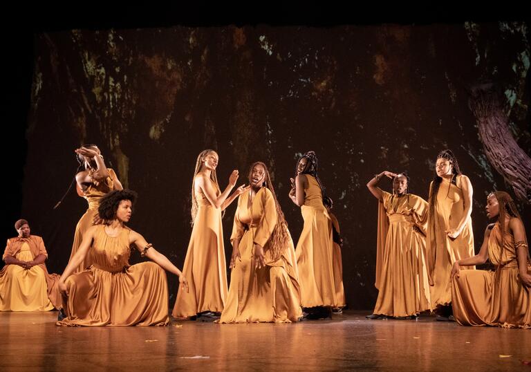 A group of women posed on stage