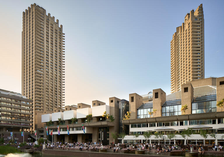 A wide shot photograph of the Barbican Lakeside Terrace in sunlight