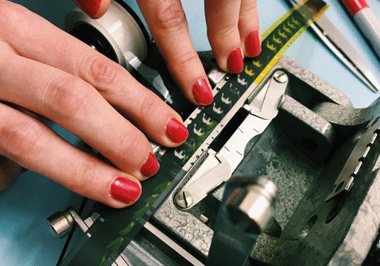 Image of a person's hand fixing a n old camera