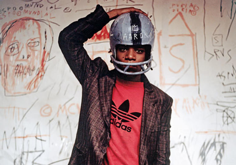 A photograph of Basquiat wearing an American football helmet