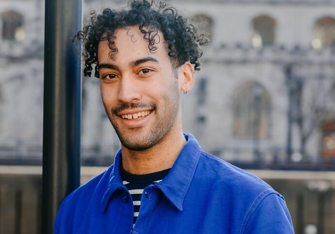 Image of Peter smiling, wearing blue jacket