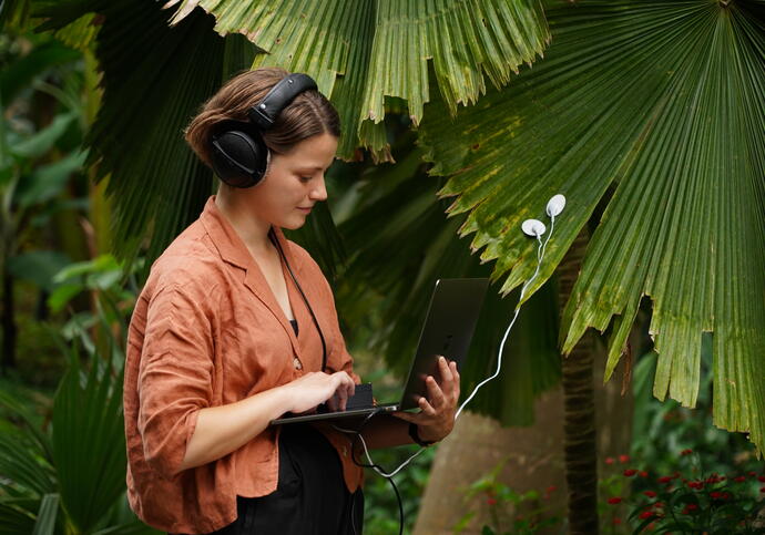 Alice Boyd wearing headphones and orange jacket