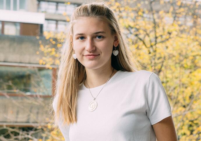 Person wearing white shirt smiling