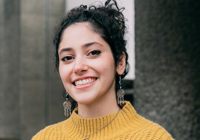 Person wearing yellow jumper smiling