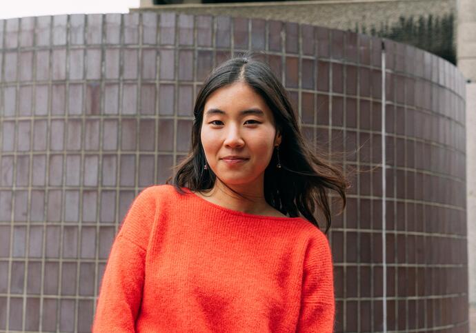 Person wearing orange jumper smiling