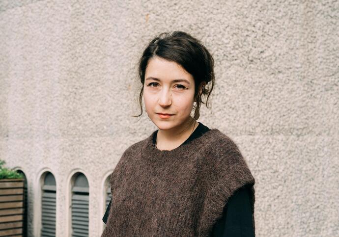 Portrait of with brown vest and black hair