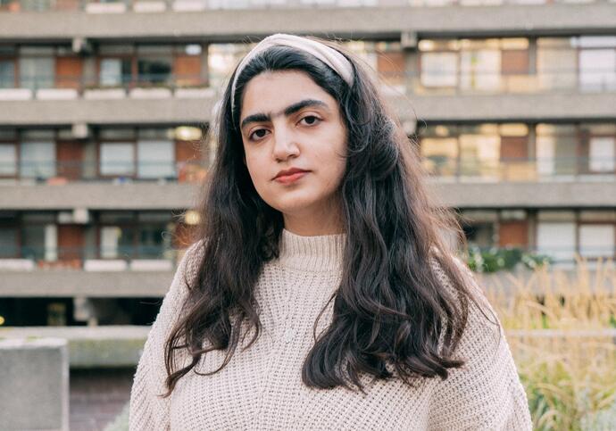 Person wearing beige jumper and headband