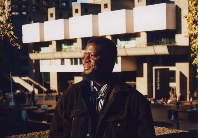 ibrahim mahama stands in front of barbican lakeside terrace