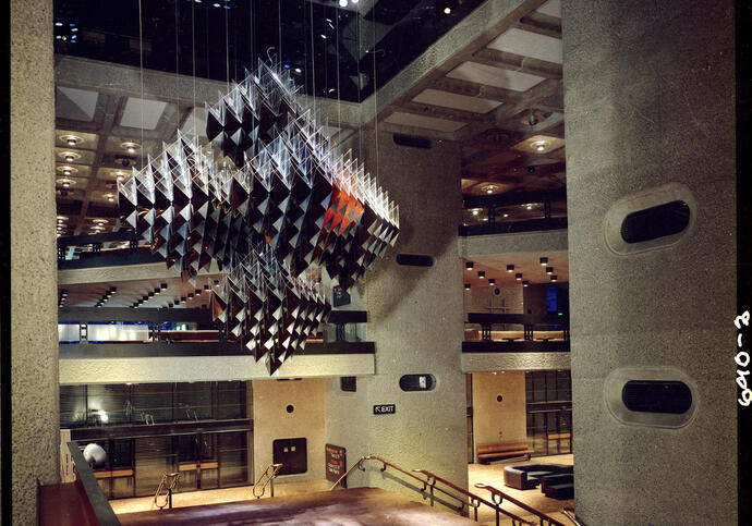 A photograph of the Barbican's original foyers in 1982, with a large geometric sculpture suspended from the ceiling