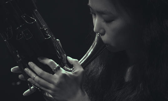 Park Jiha playing a traditional wind instrument