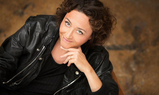 Nathalie Stutzmann smiling at camera which hand under chin